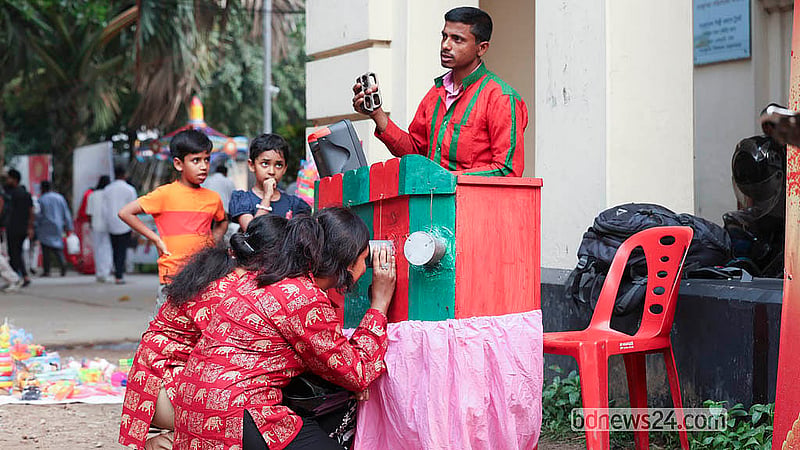 Visitors enjoy watching a Bioscope at the Baishakhi Fair on the Bangla Academy premises on Saturday, Apr 18, 2026.