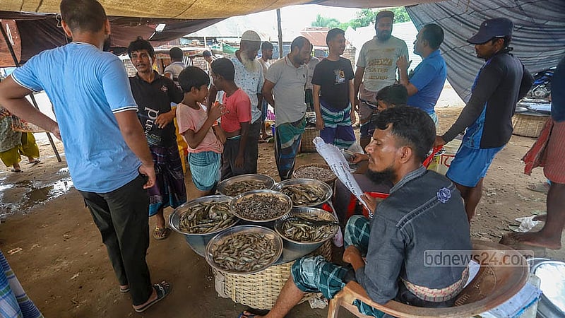 During the monsoon season, fewer fish arrive at Baidyer Bazar in Sonargaon. Local residents and fishermen blame pollution from nearby factories built along the riverbank.  Photo: Abdullah Al Momin