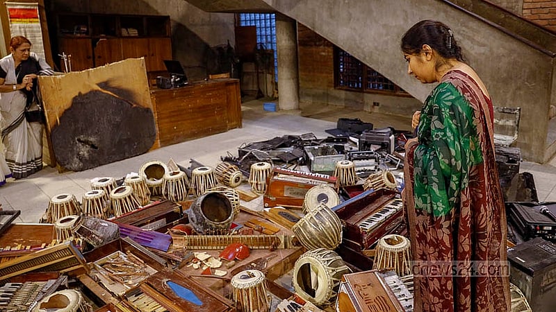 A former student looks at his broken harmonium inside Chhayanaut on Tuesday, Dec 23, 2025, days after musical instruments were destroyed in the attack. Photo: Mahmud Zaman Ovi