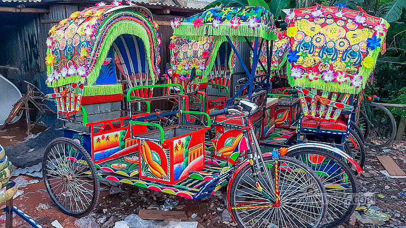 Several battery-run rickshaws await delivery at a workshop in Dhaka’s Rayerbazar.