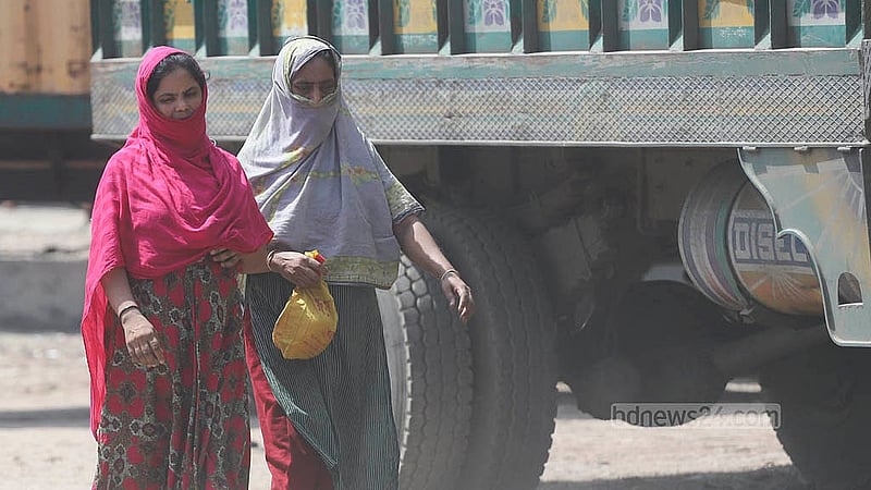 Due to extreme dust pollution, people traversing the Beribadh Road in the capital are often forced to wear masks for protection. Photo: Abdullah al Momin