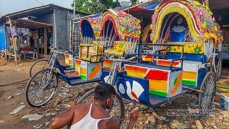 A worker paints a battery-run rickshaw after it has been assembled at a workshop in Dhaka’s Rayerbazar.