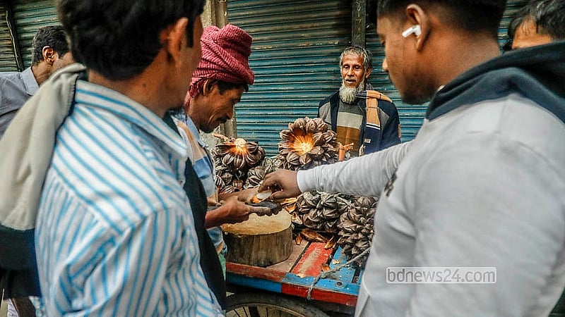 Many flock to a mobile vendor to try the Gol Fol, as it is relatively new for Dhaka residents. Each fruit is sold for Tk 10 - 20. Photo: Abdullah Al Momin