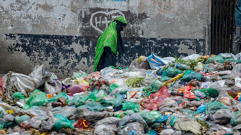 A footpath runs alongside the Shubhadda Canal in South Keraniganj, but the waste has piled up so high that in some places, it reaches the waist and even the chest of the person walking.