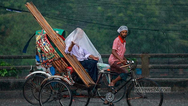 A rickshaw passenger uses a polythene sheet to get relief from the rain on Thursday afternoon, Sept 26, 2024.Photo: Mahmud Zaman Ovi