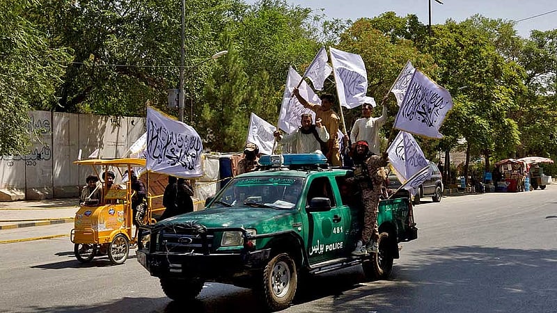 FILE PHOTO: Members of the Taliban carrying flags participate in a rally to mark the third anniversary of the fall of Kabul, in Kabul, Afghanistan, August 14, 2024. REUTERS
