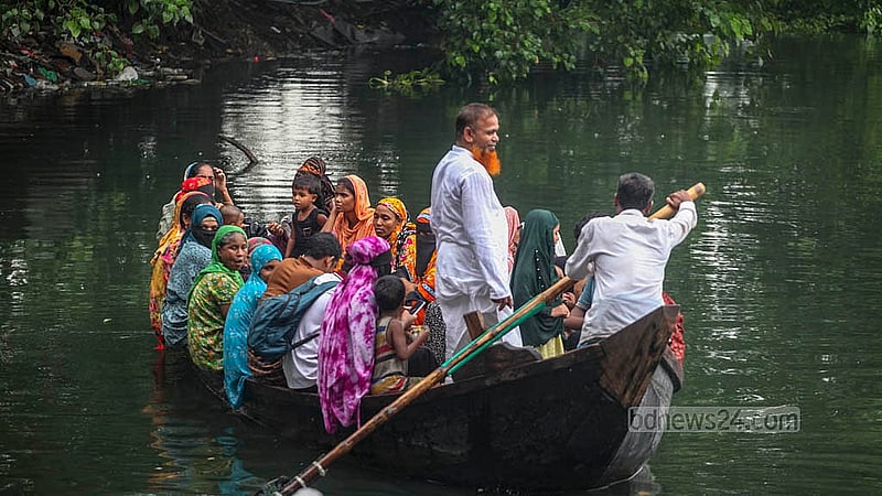 Locals cross the canal in Korail slum, located between Gulshan, Banani and Mohakhali - one of the few places in Dhaka where people can still travel by boat.
