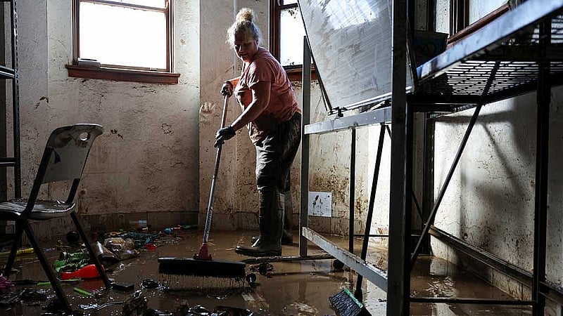 A volunteer cleans up inside a flood affected support centre in Taree, Australia, May 24, 2025. REUTERS