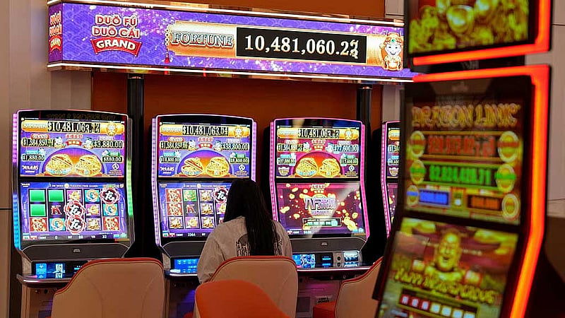 A woman plays a slot machine inside a casino at City of Dreams, an integrated resort that includes Sri Lanka's first high end casino, in Colombo, Sri Lanka, Aug 25, 2025. REUTERS