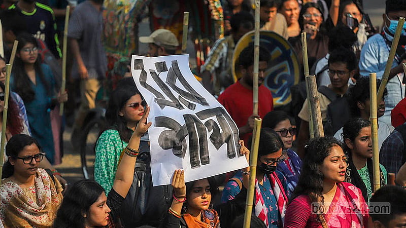 Dhaka University teachers and students, under the banner of the “Bangladesh Against Rape and Repression” platform, holding a baton march from the foot of Raju Sculpture. Photo: Abdullah al Momin