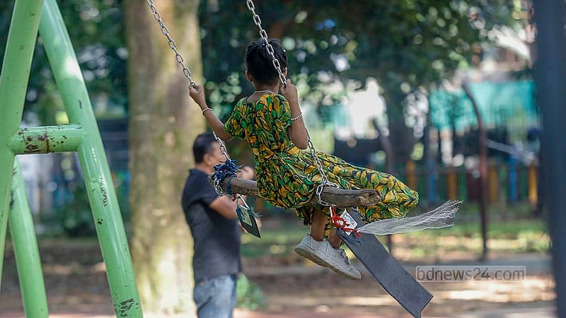 A child swings on a broken swing at Ramna Park’s children’s corner, its torn ropes held together with wood. Photo: Mahmud Zaman Ovi