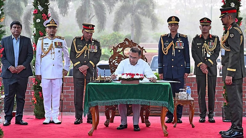 Prime Minister Tarique Rahman signs the visitors' book after paying his respects at the National Memorial in Savar on Thursday, Mar 26, 2026. Photo: PID