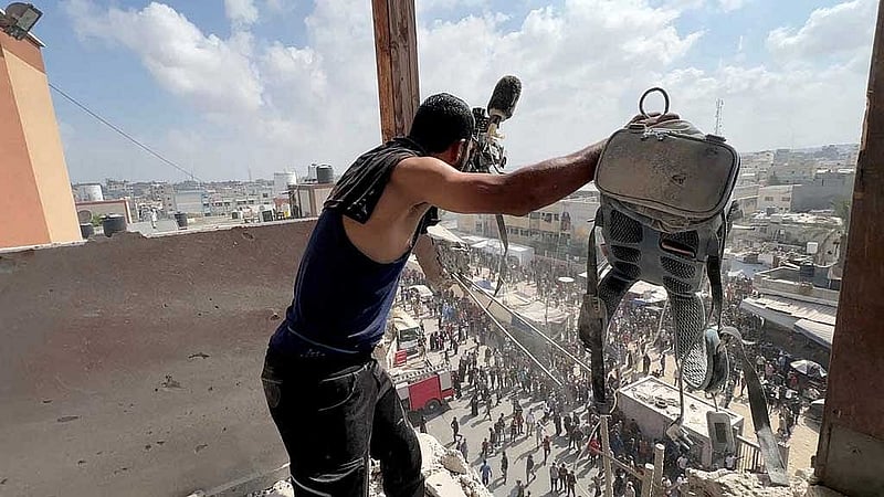 A man reacts as he holds the equipment used by Reuters cameraman Hussam al-Masri at the site where he was killed along with other journalists and people in Israeli strikes on Nasser hospital, in Khan Younis in the southern Gaza Strip, in this still image taken from a video shot by Reuters photographer Hatem Khaled, who was wounded shortly afterwards in another strike while he was filming the site, Aug 25, 2025. REUTERS
