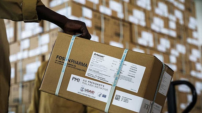A worker holds a packet of Artesunate drugs while unloading them in a warehouse in Maroua, Cameroon Sept 2, 2025. REUTERS/Desire Danga Essigue