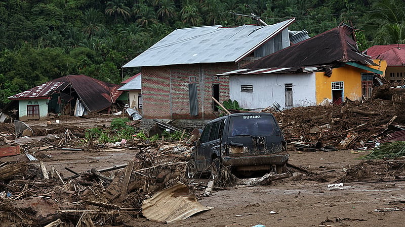 A car stuck in the mud sits among debris at an area hit by deadly flash floods following heavy rains in Palembayan, Agam regency, West Sumatra province, Indonesia, Dec 2, 2025. REUTERS/Willy Kurniawan