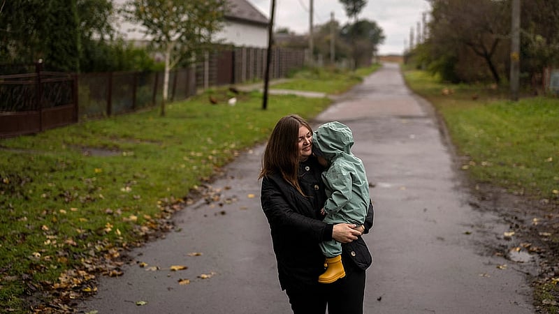 Anastasiia Tabekova, deputy chair of the Hoshcha town council, holds her two-year-old son Tymofiy in Hoshcha, a rural community that has experienced a declining birthrate, amid Russia's attack on Ukraine, in Ukraine, Oct 2, 2025. REUTERS/Thomas Peter