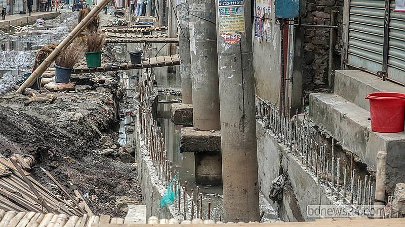 The slow progress of drainage works has left several electricity poles standing in a precarious condition along North Jurain Pipe Road in Shyampur. Photo: Abdullah Al Momin