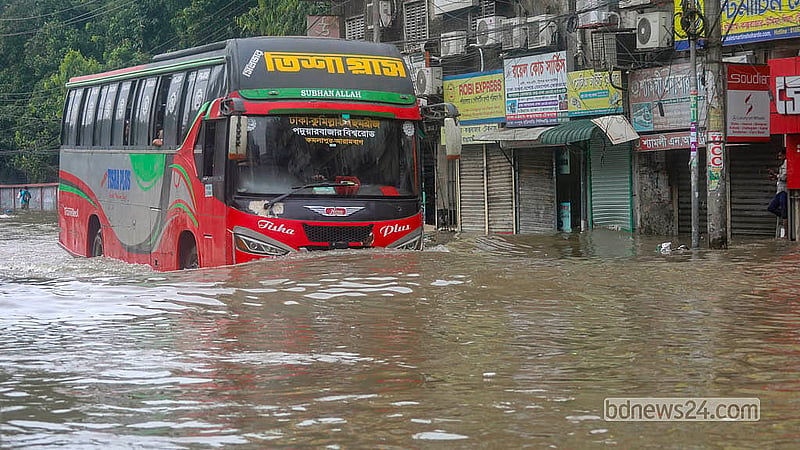 Waist-deep floodwater engulfs the Arambagh road after hours of relentless rain on Sunday, Jul 12, 2026.  Photo: Abdullah Al Momin