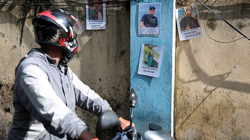 A man looks at pictures of missing people following flash floods and a mudslide, at the Trauma Center in Kathmandu, Nepal, Aug 28, 2026. REUTERS