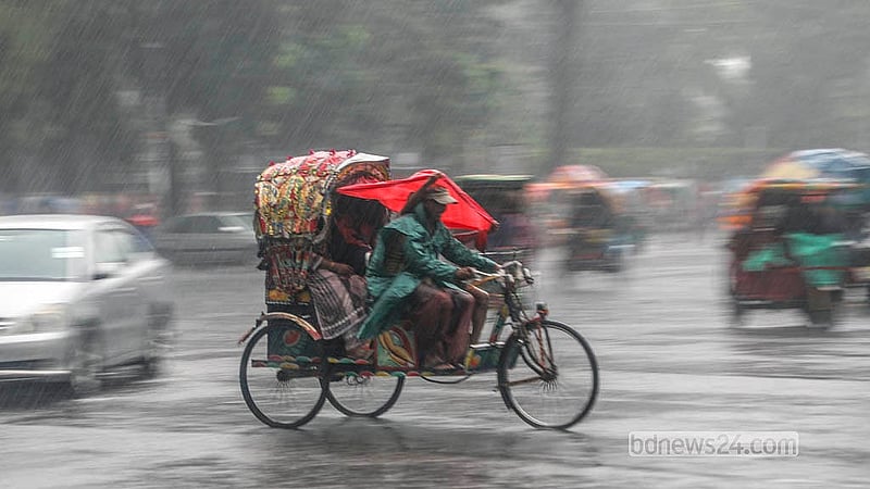 A rickshaw puller continues his journey with passengers despite the rain. Photo taken in Dhaka University.  Photo: Abdullah Al Momin