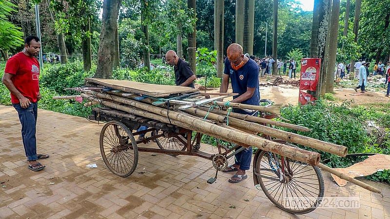 Different items are being removed after illegal structures were demolished in Suhrawardy Udyan on Sunday, Jun 26, 2026.  Photo: Abdullah Al Momin