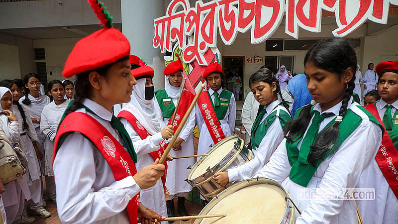 Students who passed their SSC exams at Manipur High School celebrate with music after their results are released.