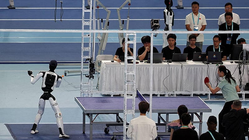 Smash, a humanoid robot developed by Kinetix AI and researchers from Hong Kong University, takes part in a table tennis exhibition match against Chinese former table tennis player Ding Ning, during the opening ceremony for the second World Humanoid Robot Games at the National Speed Skating Oval in Beijing, China Aug 22, 2026. REUTERS/Florence Lo