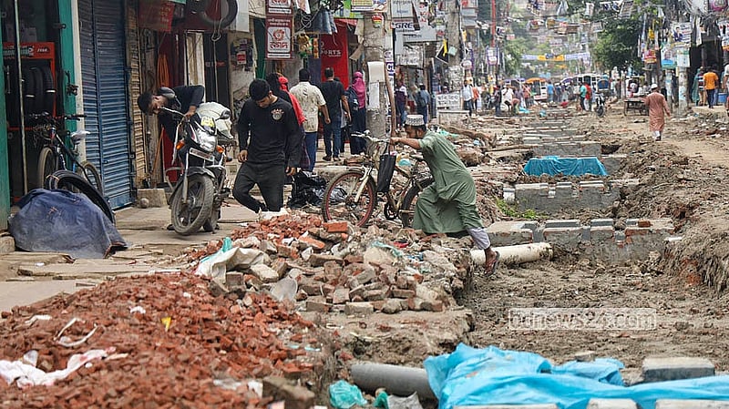 A cyclist struggles through the roadworks in South Basabo, where the street has been dug up for repairs.   Photo: Shamsul Haque Ripon