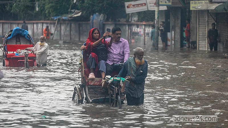 Waist-deep floodwater engulfs the Arambagh road after hours of relentless rain on Sunday, Jul 12, 2026.  Photo: Abdullah Al Momin