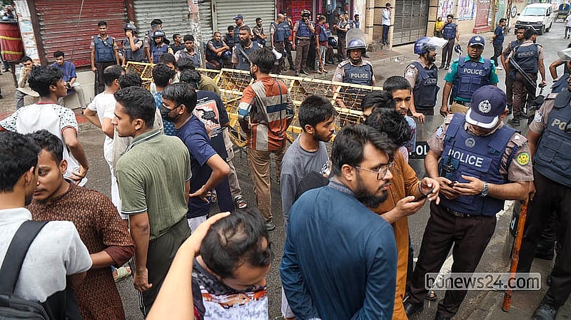 Police stand behind barbed-wire barricades at the entrance after Tuesday’s clash between Jatiotabadi Chhatra Dal and Islami Chhatra Shibir at the madrasa campus in Bakshibazar on Wednesday, Aug 5, 2026.  Photo: Shamsul Haque Ripon