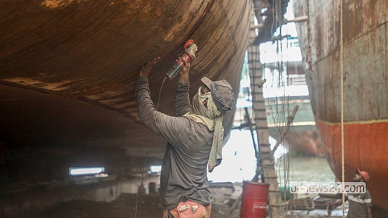 A worker repairs a boat at a dockyard in Dhaka’s Keraniganj. Photo: Abdullah Al Momin