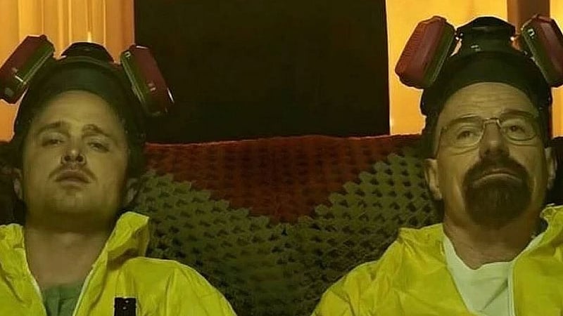 Aaron Paul and Bryan Cranston sit in yellow hazmat suits during a scene from Season 5, Episode 3 of Breaking Bad, titled &amp;quot;Hazard Pay&amp;quot;, where their characters Jesse Pinkman and Walter White pause for a beer while cooking inside a tented house. Photo: Breaking Bad/ Facebook