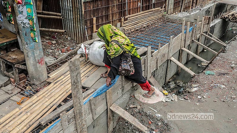 Residents navigate hazardous conditions as slow-moving drainage repairs continue along North Jurain Pipe Road in Shyampur. Photo: Abdullah Al Momin