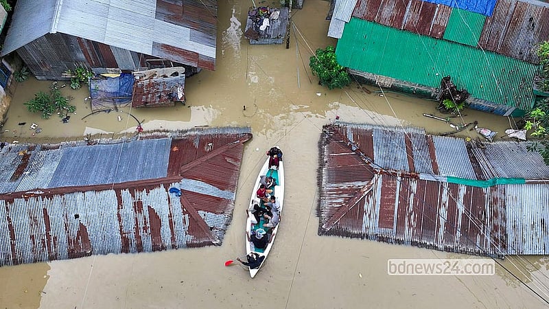 People travel in boats on the road in Islampur of Bandarban city on Saturday, Jul 11, 2026. Photo: Syed Amir Hosain Masum