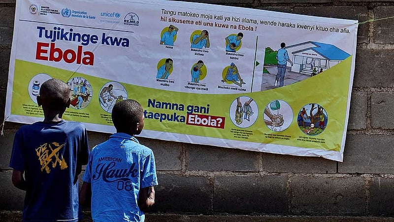 Congolese children read an advocacy poster as aid agencies intensify efforts to contain a new Ebola outbreak involving the Bundibugyo strain outbreak, in Bunia, Ituri province, Democratic Republic of Congo, May 20, 2026. REUTERS/Gradel Muyisa Mumbere/File Photo