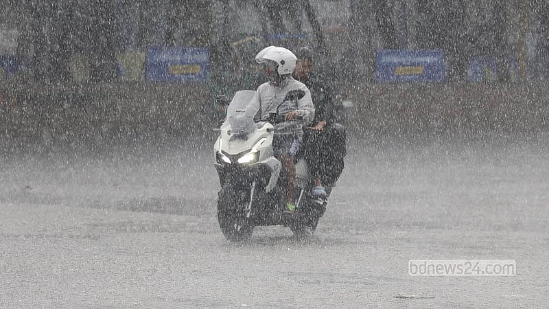 A motorcyclist rides through the downpour, caught unprepared as Dhaka is drenched by heavy monsoon rain on Saturday, Jun 13, 2026.  Photo: Shamsul Haque Ripon