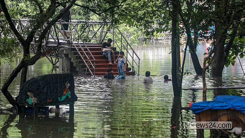 Children and teenagers enjoy playing in the overflowing waters of Dhanmondi Lake.  Photo: Abdullah Al Momin
