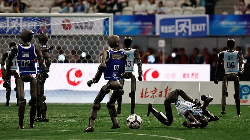 Humanoid Robots by Booster Robotics take part in a football exhibition match ahead of the opening ceremony of the 2026 World Humanoid Robot Games, at the National Speed Skating Oval, in Beijing, China Aug 22, 2026. REUTERS/Tingshu Wang
