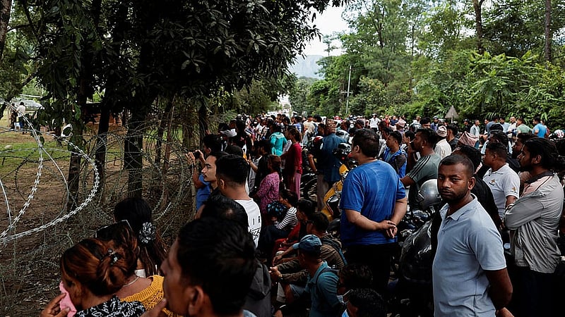 People gather as flood-affected people are brought to Maithali Barrack, an Army training centre, which serves as a primary base, after being rescued and airlifted following flash floods and mudslide at Trishuli in Nuwakot district, Nepal, Aug 27, 2026. REUTERS