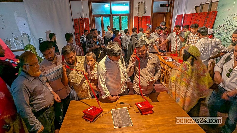 Visitors listen to different conversations on the red phone used by Sheikh Hasina at Ganabhaban at the July Mass Uprising Memorial Museum on Thursday, Aug 6, 2026. Photo: Abdullah Al Momin