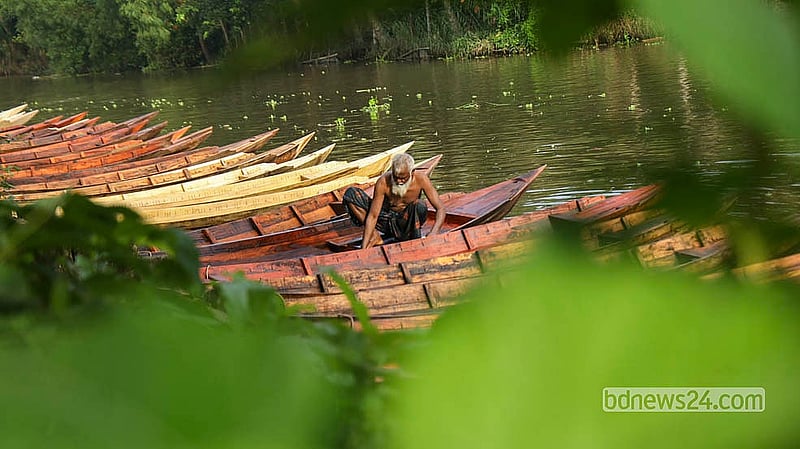 Some buyers arrive at the market by boat, looking to take home another.  Photo: Shamsul Haque Ripon
