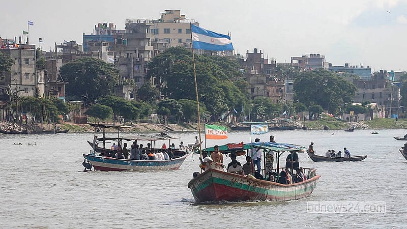 Football fever has reached the waterways, with everything from small wooden boats to passenger launches flying the colours of World Cup nations. Photo: Abdullah Al Momin