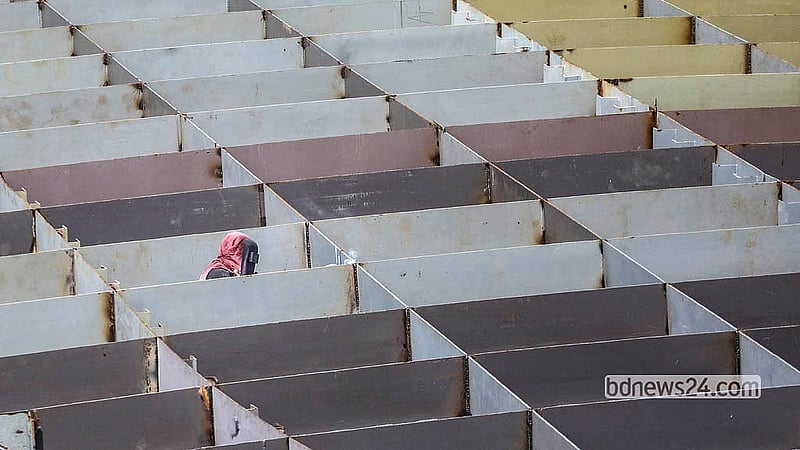 A worker repairs a boat at a dockyard in Dhaka’s Keraniganj. Photo: Abdullah Al Momin