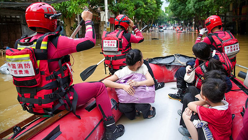 Rescue workers evacuate flood-affected residents by boat after heavy rainfall brought by typhoon Narra caused flooding in Longzhou county, Chongzuo, Guangxi Zhuang Autonomous Region, China Aug 24, 2026. Photo: Reuters