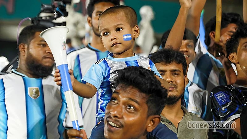 A man brings his child to Dhaka University to watch the match between Argentina and Cape Verde on the big screen on Saturday, Jul 4, 2026.   Photo: Shamsul Haque Ripon
