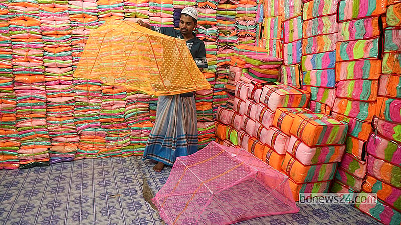 A customer examines a “magic” or “umbrella” mosquito net designed especially for children at the Bhulta Gausia market in Narayanganj.  Photo: Shamsul Haque Ripon