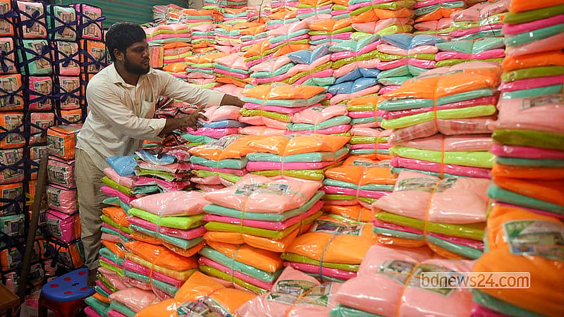 A trader arranges stacks of mosquito nets in different colours and sizes at Bhulta Gausia, Narayanganj.   Photo: Shamsul Haque Ripon