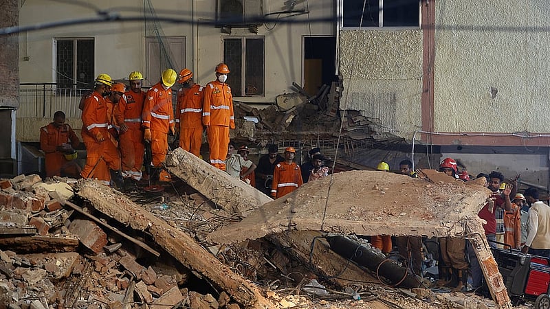National Disaster Response Force (NDRF) personnel watch as debris is lifted, during a rescue operation at the site of a building collapse in New Delhi, India, Sept 6, 2026. REUTERS/Francis Mascarenhas