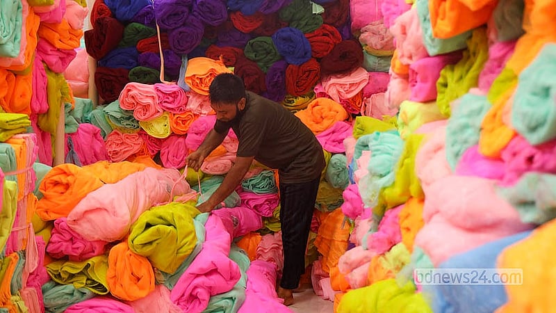 A trader prepares colourful netting fabric for wholesale at the Bhulta Gausia market in Rupganj, Narayanganj.  Photo: Shamsul Haque Ripon