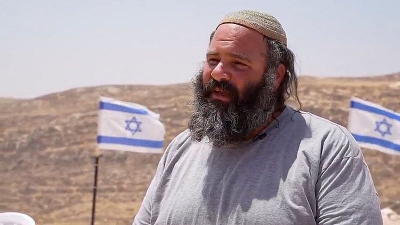 Israeli settler Eliav Libi, of the Malachei Hashalom settlers outpost in the West Bank, speaks as he visits the memorial grave of his son David Libi in the Israeli-occupied West Bank, in this screen grab from an undated video. Channel 7/Handout via REUTERS. 